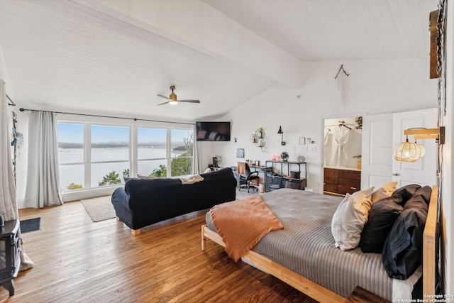 bedroom featuring ceiling fan, lofted ceiling with beams, and hardwood / wood-style floors