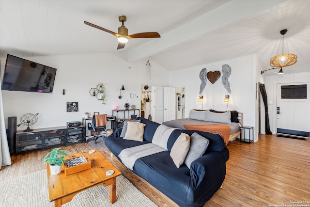 living room with light hardwood / wood-style floors, lofted ceiling with beams, and ceiling fan