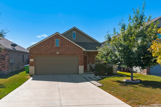 view of front of house with a front yard and a garage