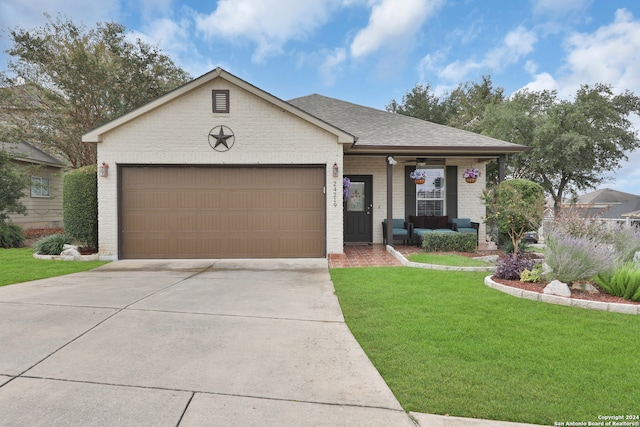 view of front of home featuring a front yard and a garage