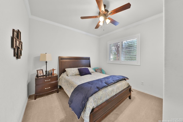 bedroom featuring ceiling fan, ornamental molding, and light colored carpet