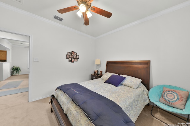 carpeted bedroom with ceiling fan and crown molding