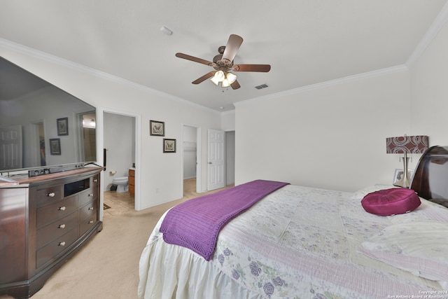 carpeted bedroom featuring ornamental molding, ensuite bathroom, and ceiling fan