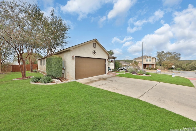 ranch-style home with a front yard and a garage