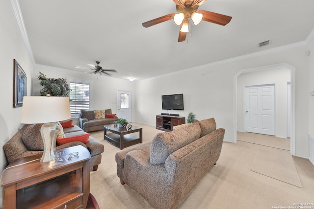 carpeted living room with crown molding and ceiling fan