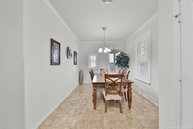 dining area with crown molding, a notable chandelier, and light tile patterned flooring