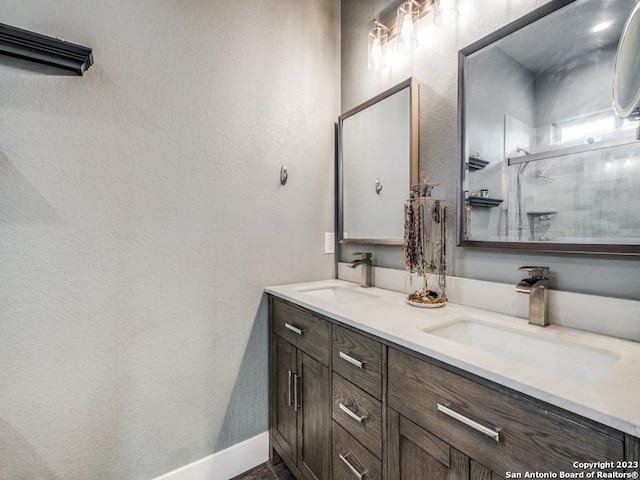 338 Salt Grass Trl, Bandera, TX 78003 - bathroom with double vanity, a shower stall, and baseboards