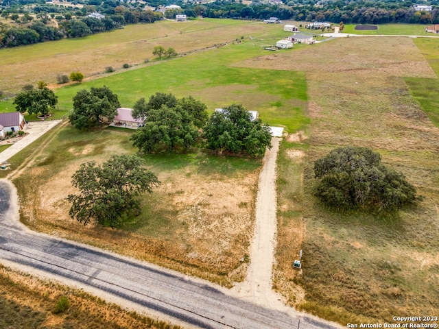 birds eye view of property with a rural view