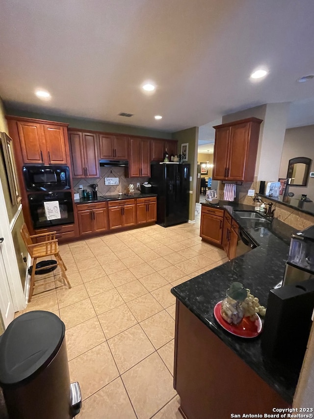 kitchen featuring kitchen peninsula, tasteful backsplash, light tile patterned floors, black appliances, and sink