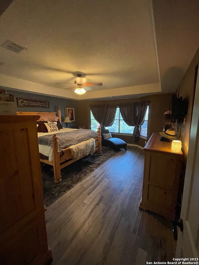 bedroom with ceiling fan and dark hardwood / wood-style flooring