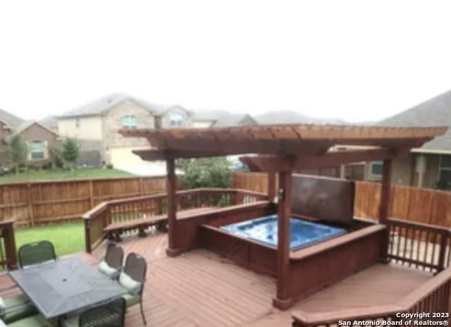 wooden terrace with an outdoor hot tub