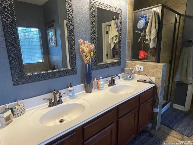 bathroom with vanity, an enclosed shower, and tile patterned flooring