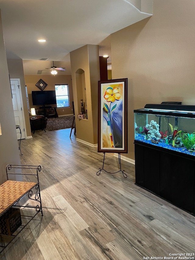 game room featuring light hardwood / wood-style floors and ceiling fan