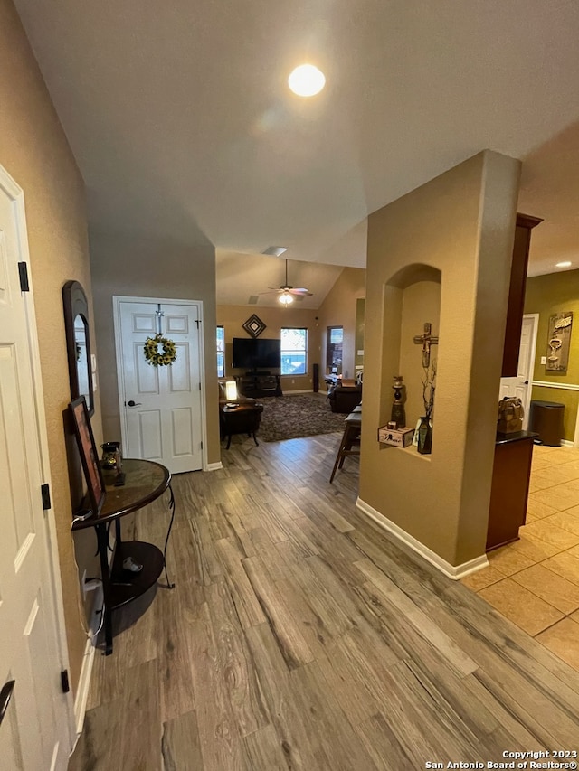 entrance foyer with vaulted ceiling, light hardwood / wood-style floors, and ceiling fan