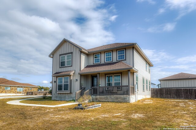 view of front of house featuring covered porch and a front yard