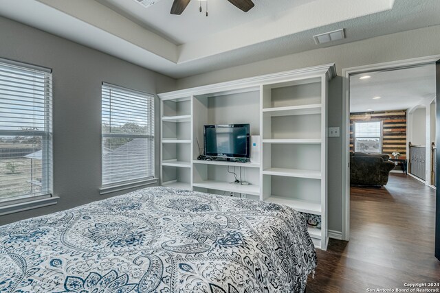 bedroom with ceiling fan and dark hardwood / wood-style floors