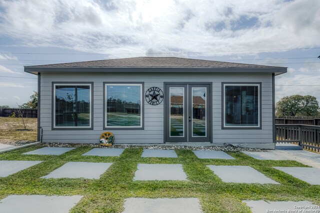 rear view of property featuring french doors and a patio area