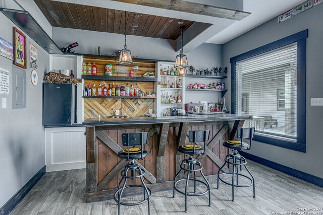 bar with wood ceiling, hardwood / wood-style flooring, electric panel, and hanging light fixtures