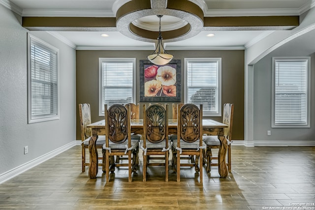 dining area featuring beam ceiling, crown molding, and wood-type flooring