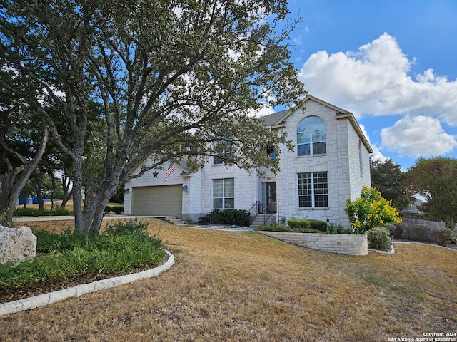 view of front of house with a front lawn and a garage