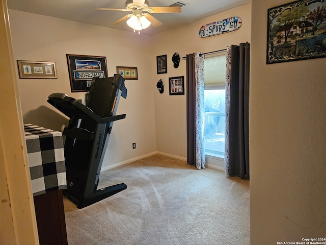 workout area with light carpet and ceiling fan