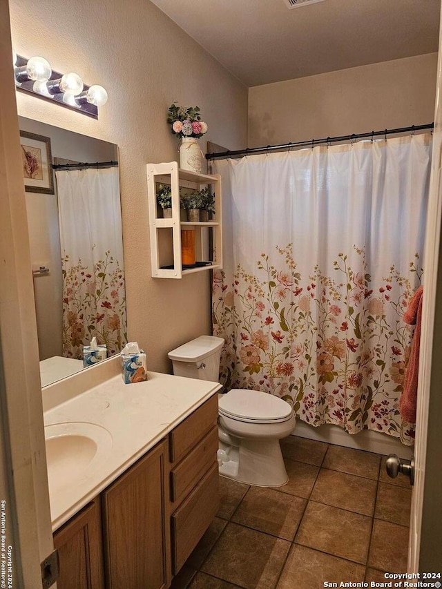 bathroom featuring vanity, toilet, a shower with curtain, and tile patterned flooring