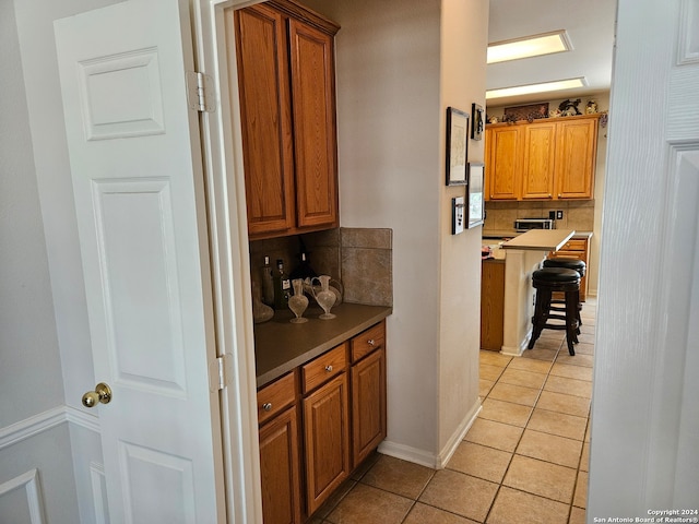 kitchen featuring backsplash and light tile patterned floors