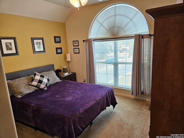 bedroom featuring light carpet and lofted ceiling