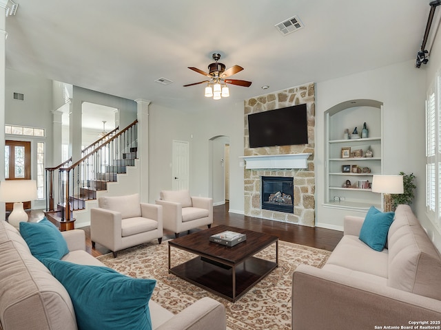 819 Tiger Lily, San Antonio, TX 78260 - living room featuring built in shelves, ceiling fan, wood finished floors, a fireplace, and stairs