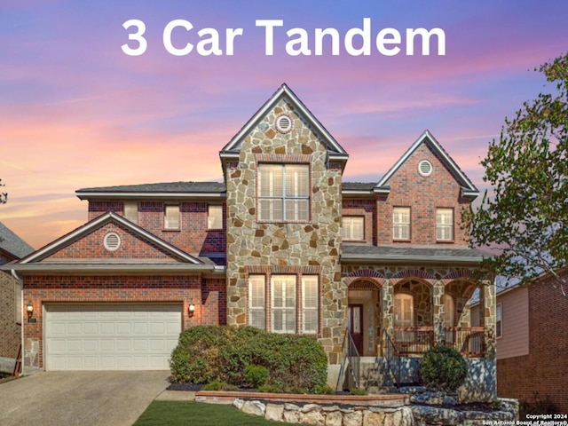 819 Tiger Lily, San Antonio, TX 78260 - view of front of property featuring a porch, stone siding, driveway, and brick siding