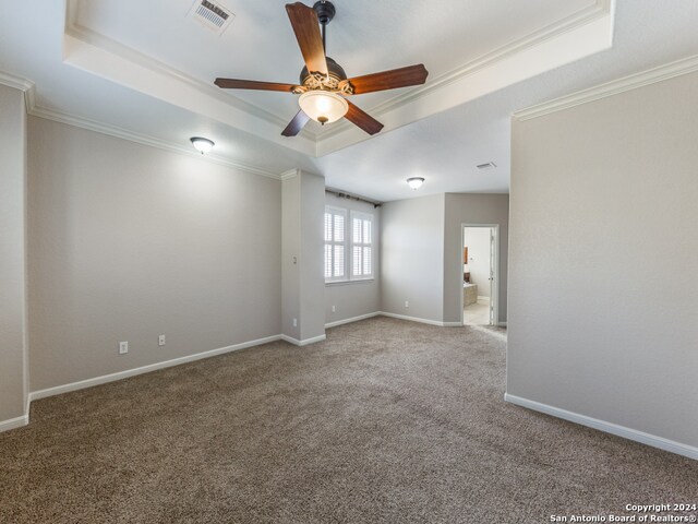 carpeted empty room with crown molding, ceiling fan, and a tray ceiling