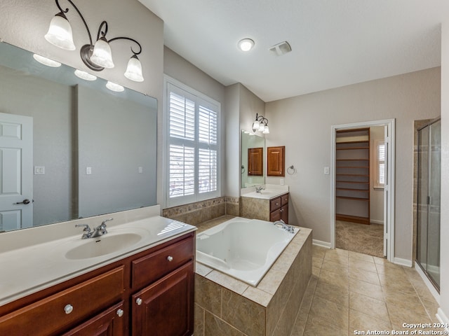 bathroom featuring tile patterned flooring, vanity, and separate shower and tub