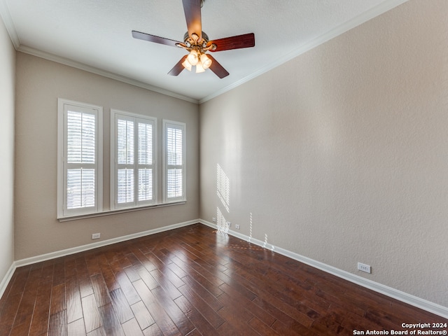 spare room featuring dark wood-type flooring, ornamental molding, and ceiling fan