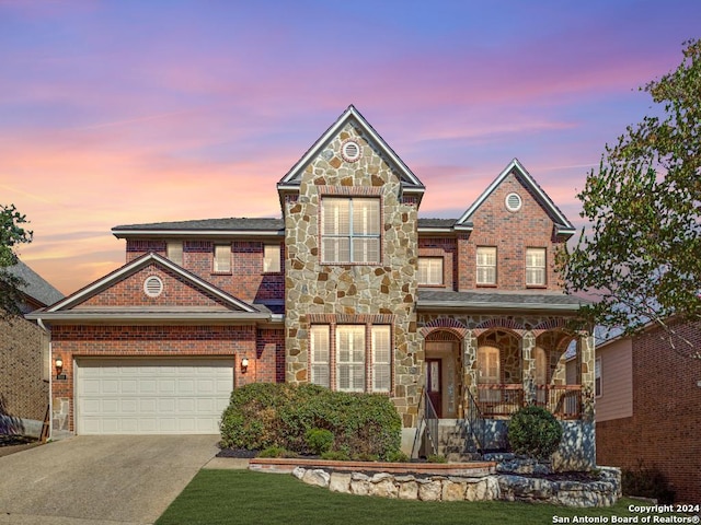 819 Tiger Lily, San Antonio, TX 78260 - view of front of home with a porch, stone siding, driveway, and brick siding