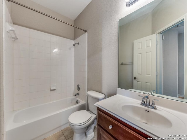 full bathroom with vanity, tiled shower / bath combo, tile patterned floors, and toilet