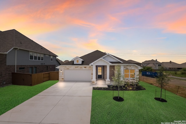 view of front of home with a yard and a garage