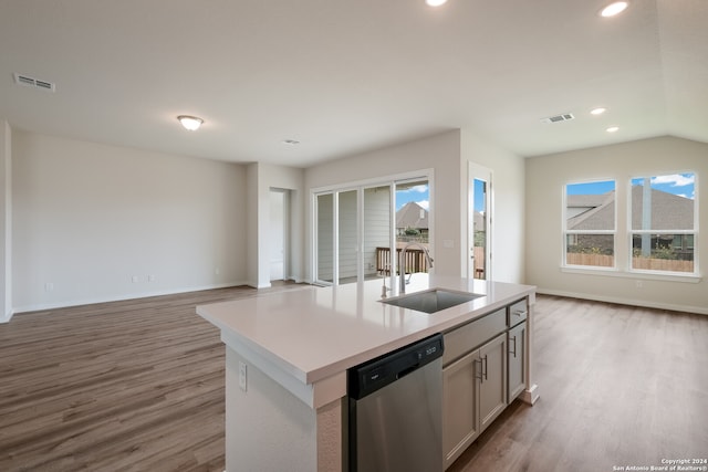 kitchen with dishwasher, sink, a center island with sink, and a wealth of natural light