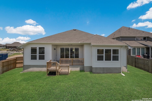 rear view of house featuring a lawn