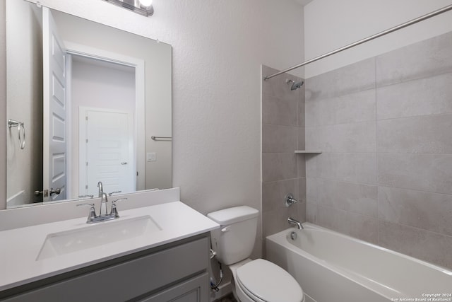 full bathroom with vanity, toilet, and tiled shower / bath combo