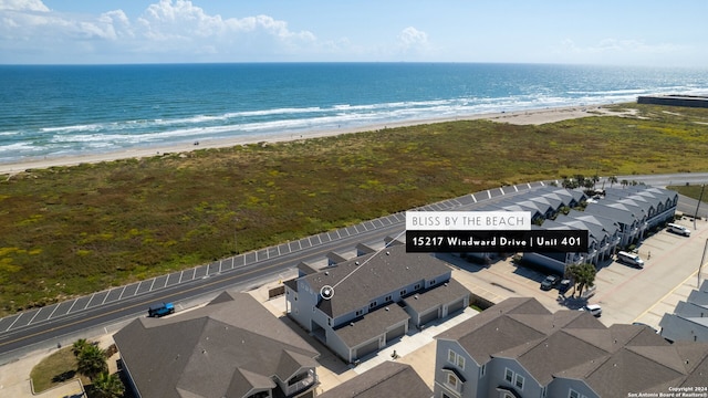 bird's eye view featuring a water view and a beach view