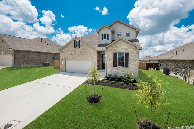 view of front of property with a front yard, central AC unit, and a garage