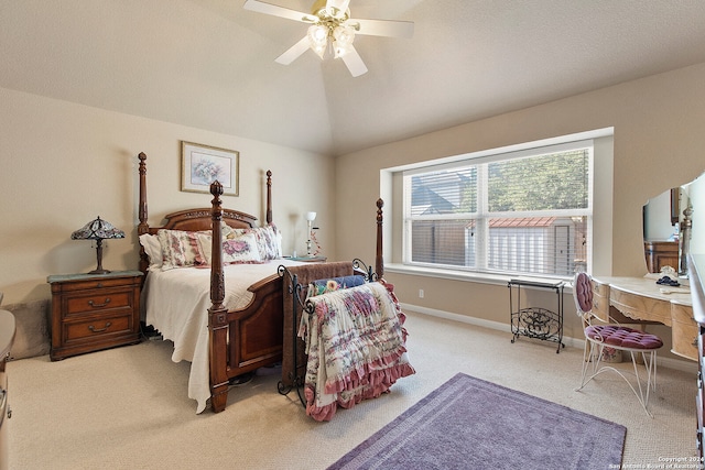 carpeted bedroom featuring ceiling fan and vaulted ceiling