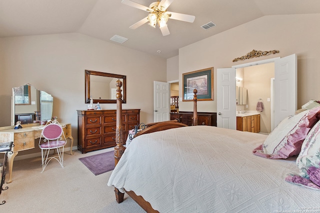 bedroom featuring ensuite bath, lofted ceiling, light carpet, and ceiling fan