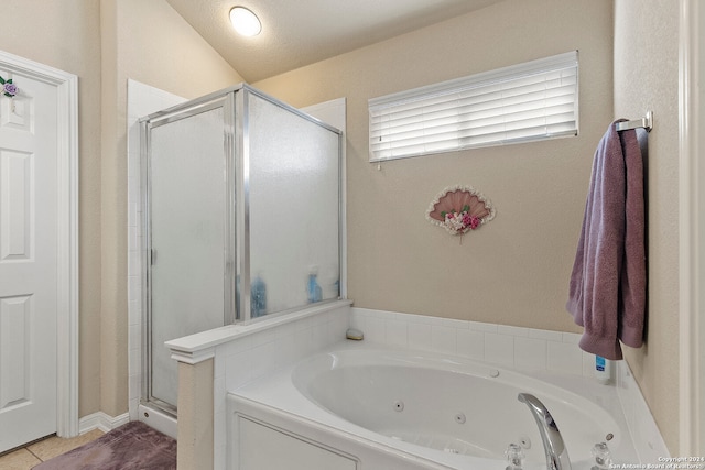 bathroom featuring lofted ceiling, plus walk in shower, and a textured ceiling