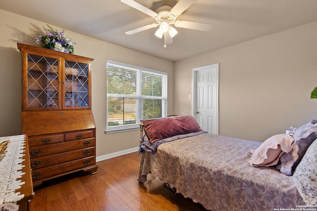 bedroom featuring a textured ceiling, hardwood / wood-style flooring, and ceiling fan