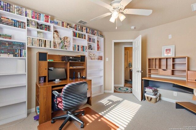 carpeted home office with ceiling fan