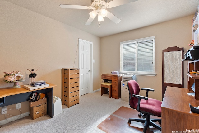 carpeted home office with ceiling fan