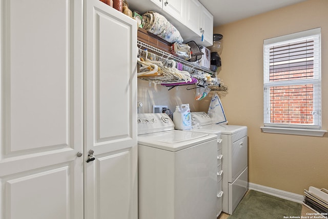 laundry room with cabinets and washer and clothes dryer