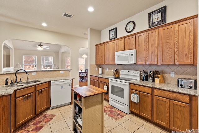 kitchen with white appliances, sink, wood counters, ceiling fan, and light tile patterned floors