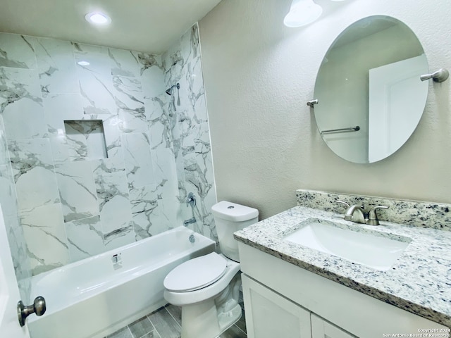 full bathroom with tiled shower / bath, vanity, and toilet